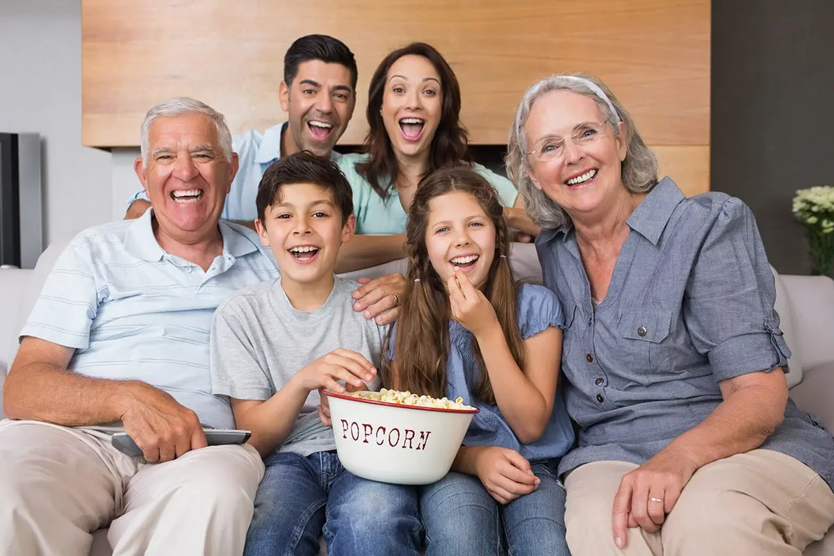 Large family home in Brampton with several generations watching TV together