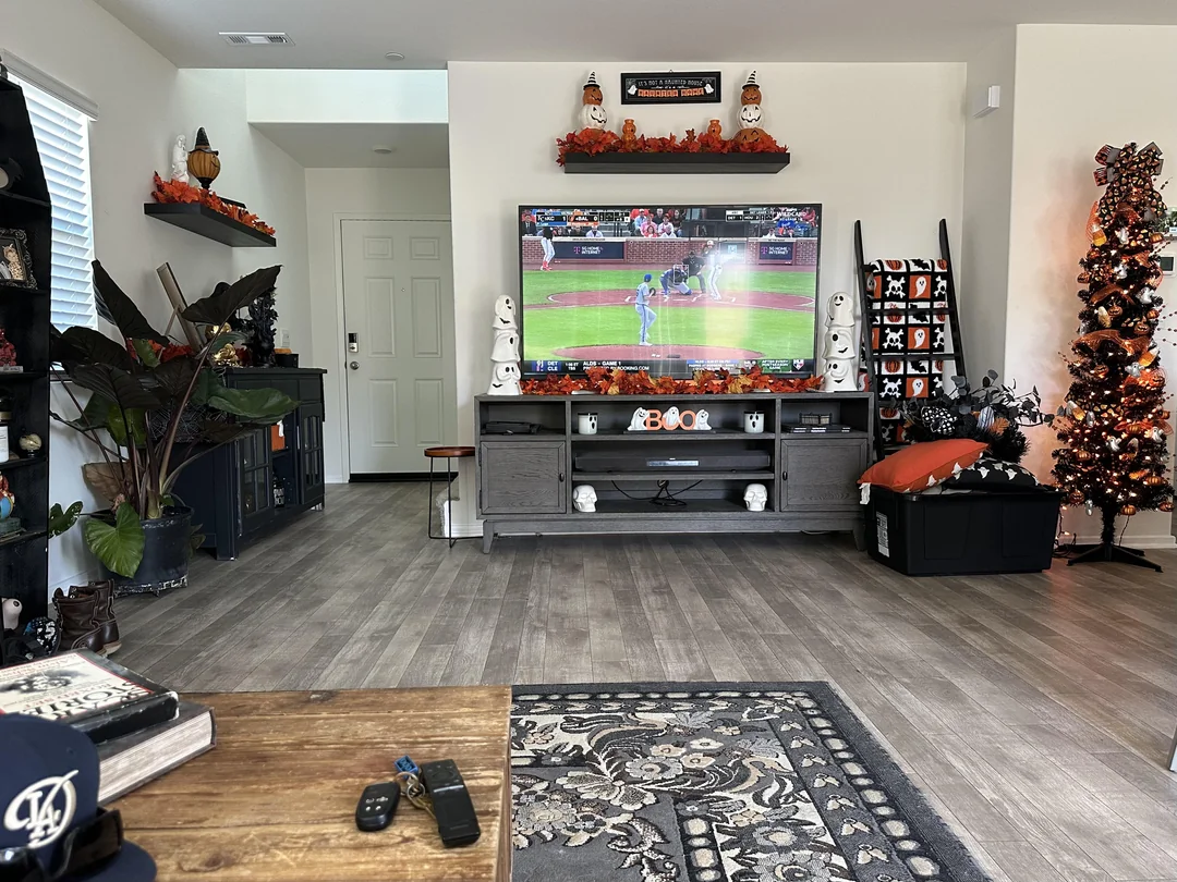 Smart TV, streaming stick, tablet and phone laid out on a living room table